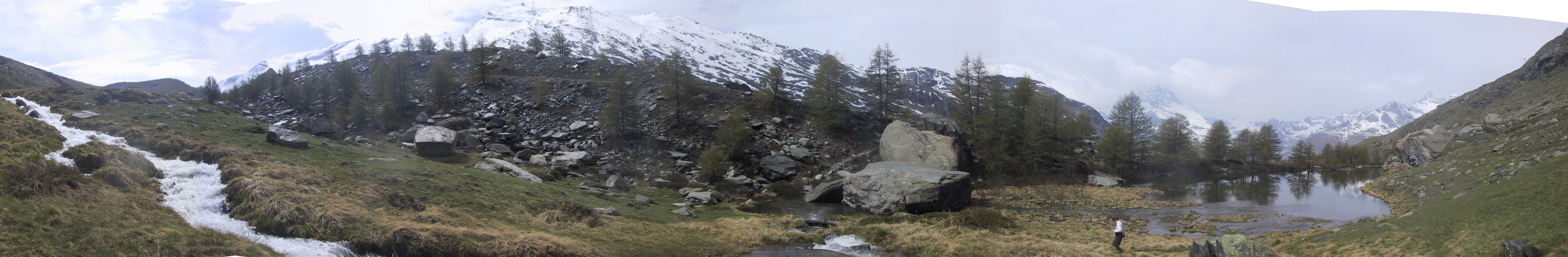 Roaring meltwater stream flowing down into Grindjisee pond.